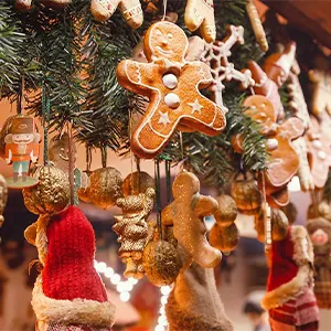 Christmas decorations with gingerbread men, stockings, ornaments, and greenery hanging together in festive display.
