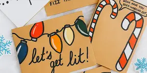 Holiday cards with Christmas lights and candy canes, one card says 'let's get lit!' in cursive text.