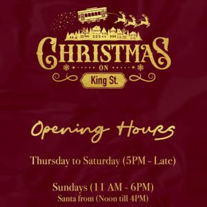 Christmas on King graphic showing opening hours on a red background. Hours listed as Thursday to Saturday, 5 PM to late, and Sundays, 11 AM to 6 PM, with Santa available from noon to 4 PM.