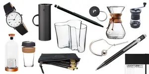 A collection of modern office and coffee accessories, including pens, mugs, glassware, and a watch.