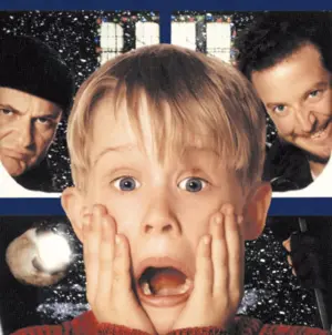 A blond boy with hands on his cheeks looks shocked as two men glare menacingly behind him.